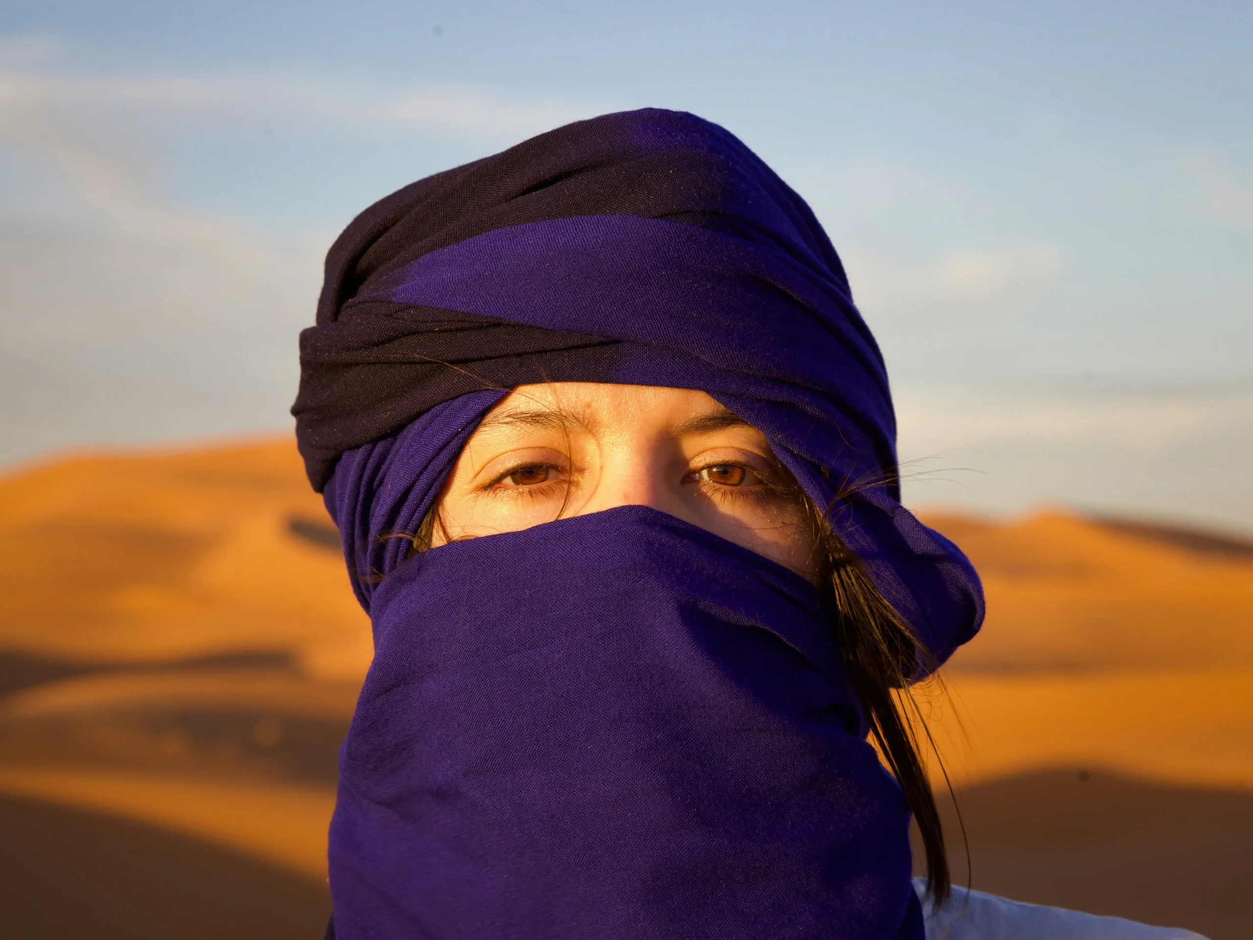 Woman in Sahara scarf exploring Moroccan medina at Morocco travel destinations