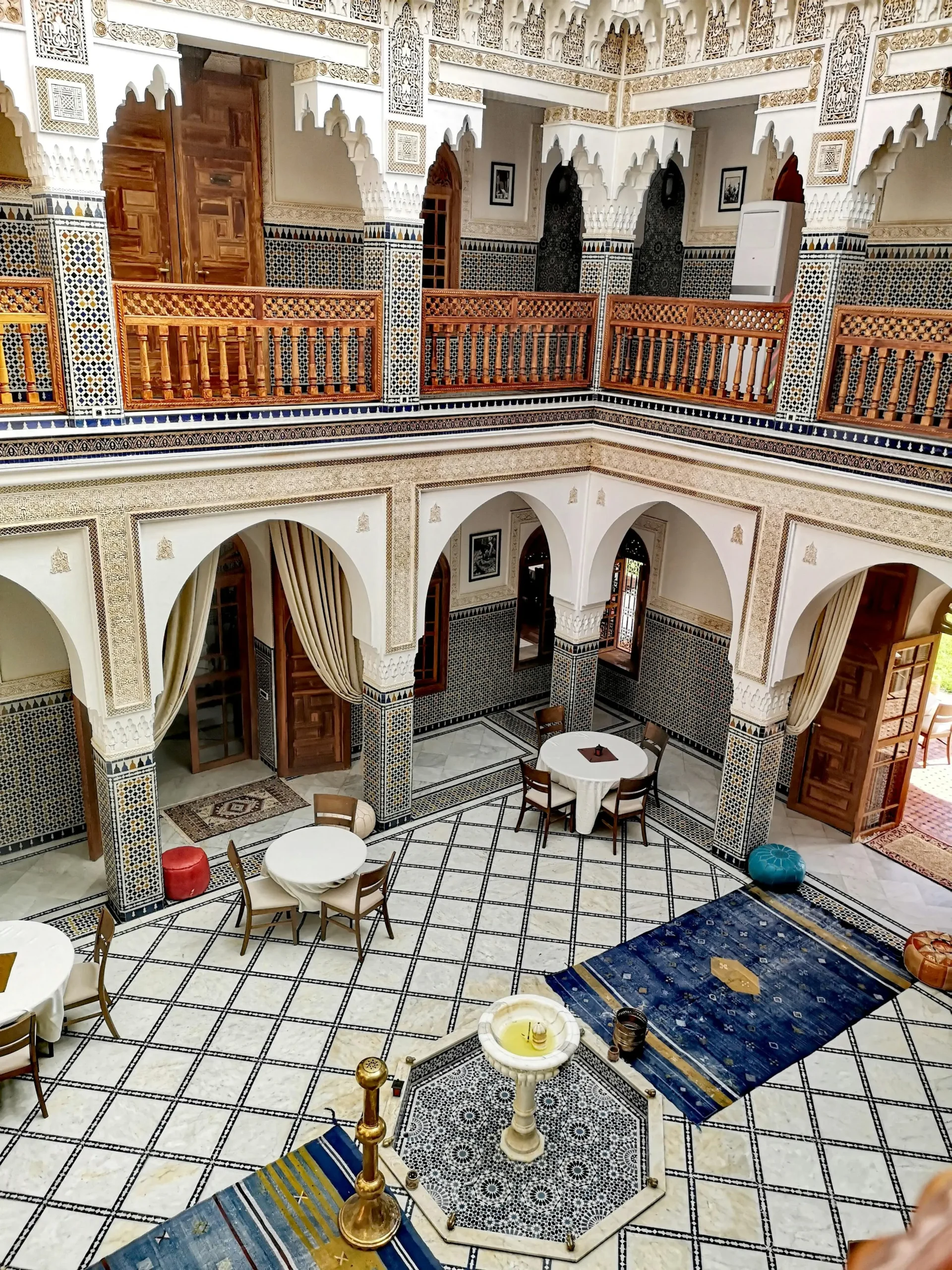 Traditional riad marrakech courtyard with fountain and moroccan tiles